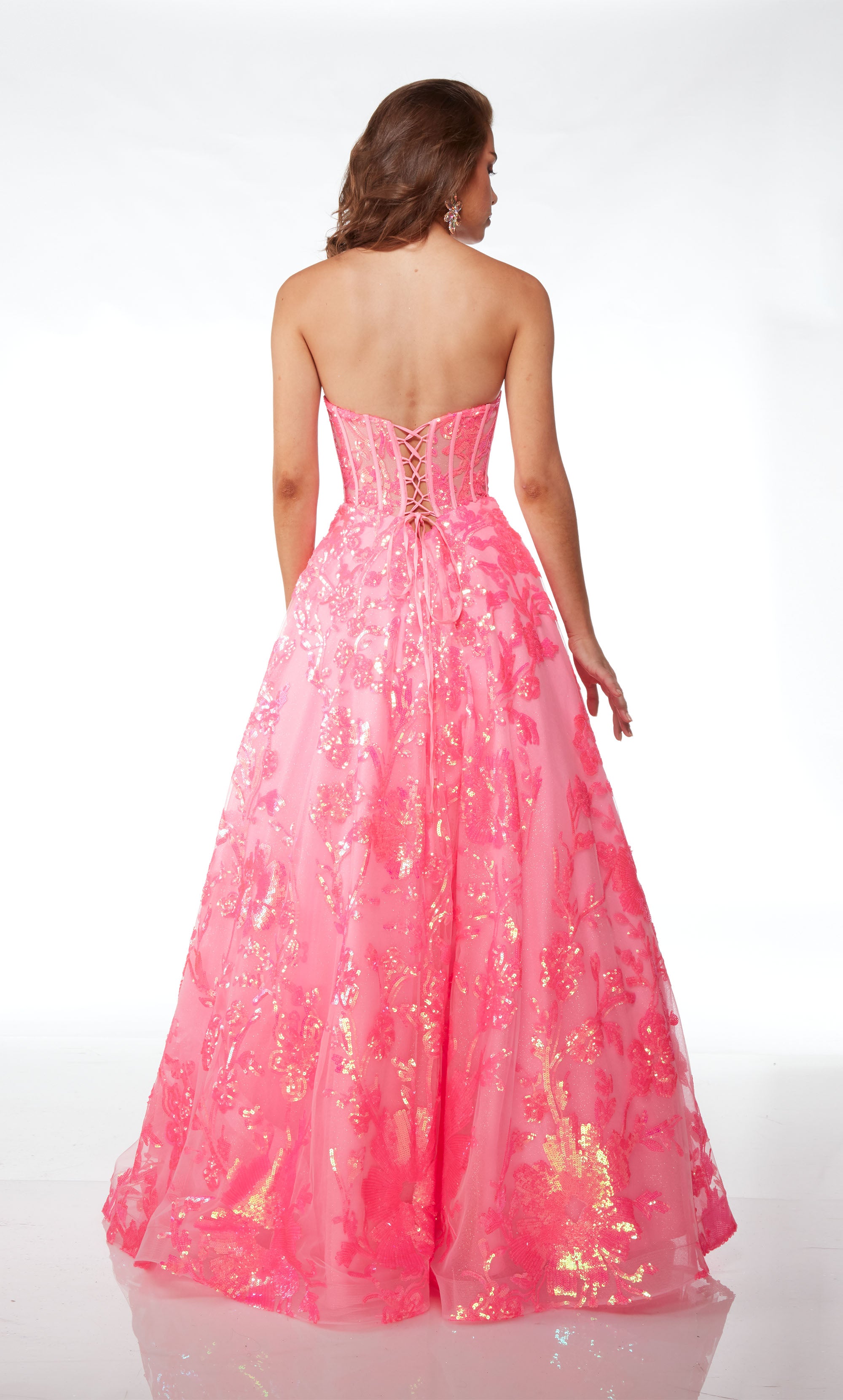 Strapless pink ball gown with an corset top, lace-up back, and iridescent sequin flowers throughout, creating an whimsical and enchanting aesthetic.