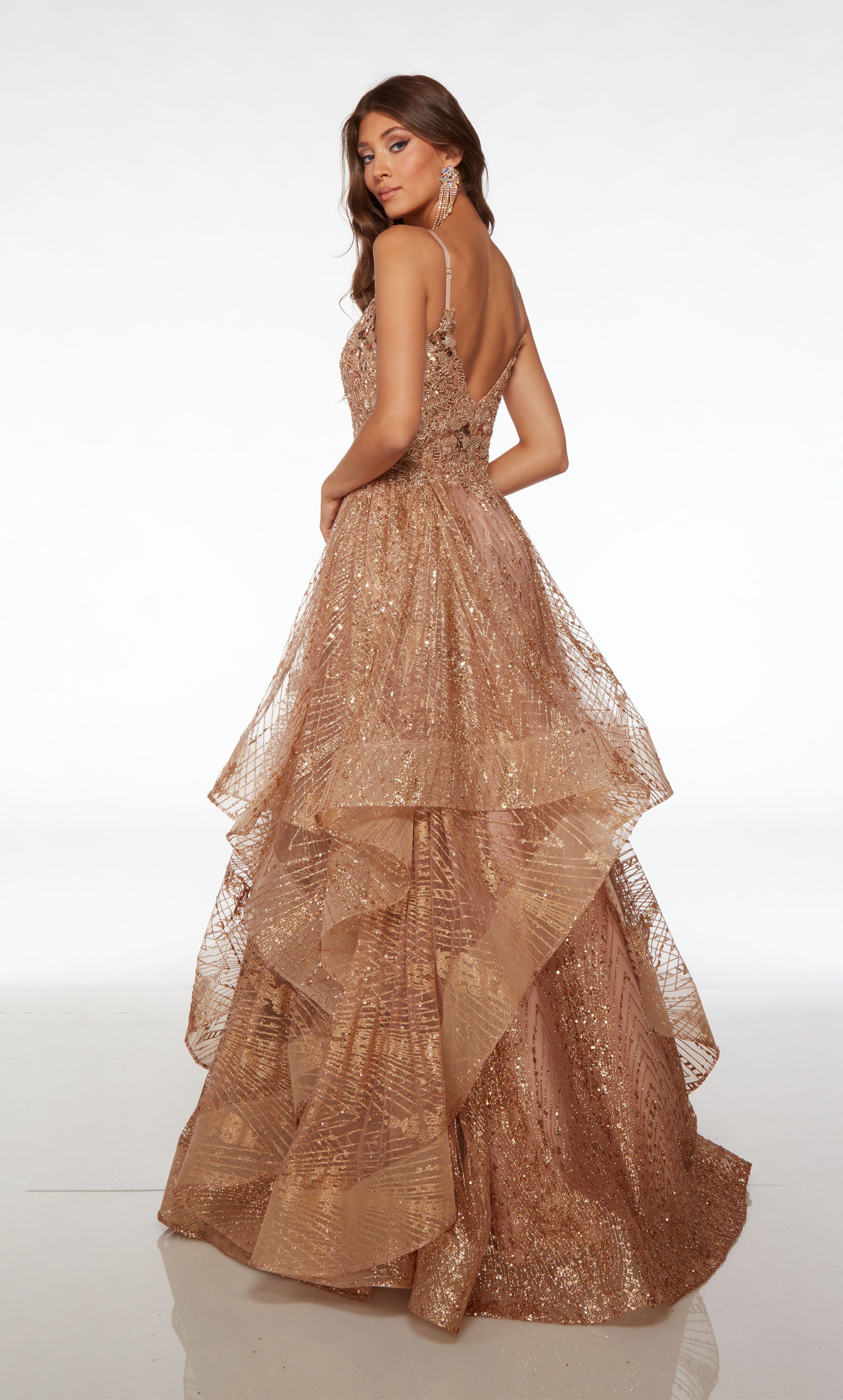 Rose gold glitter tulle ball gown with an plunging neckline, beaded lace bodice, adjustable straps, ruffled skirt, and an slight train for an glamorous look.