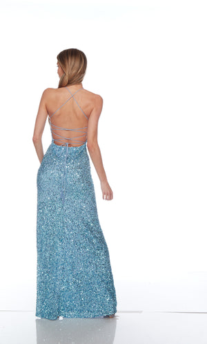 Blue sequin gown with scooped neckline, slit, and strappy lace-up back for an elegant and alluring look.